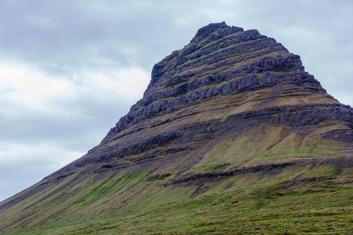 Free A stunning view of Kirkjufell Mountain in Iceland showcasing its unique shape and dramatic landscape. Stock Photo