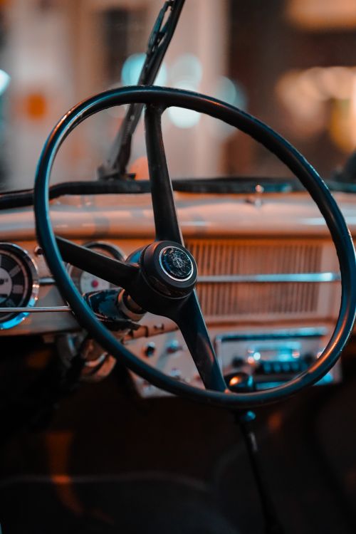 Free Close-up view of a classic vintage car interior with a retro steering wheel, highlighting timeless automotive design. Stock Photo