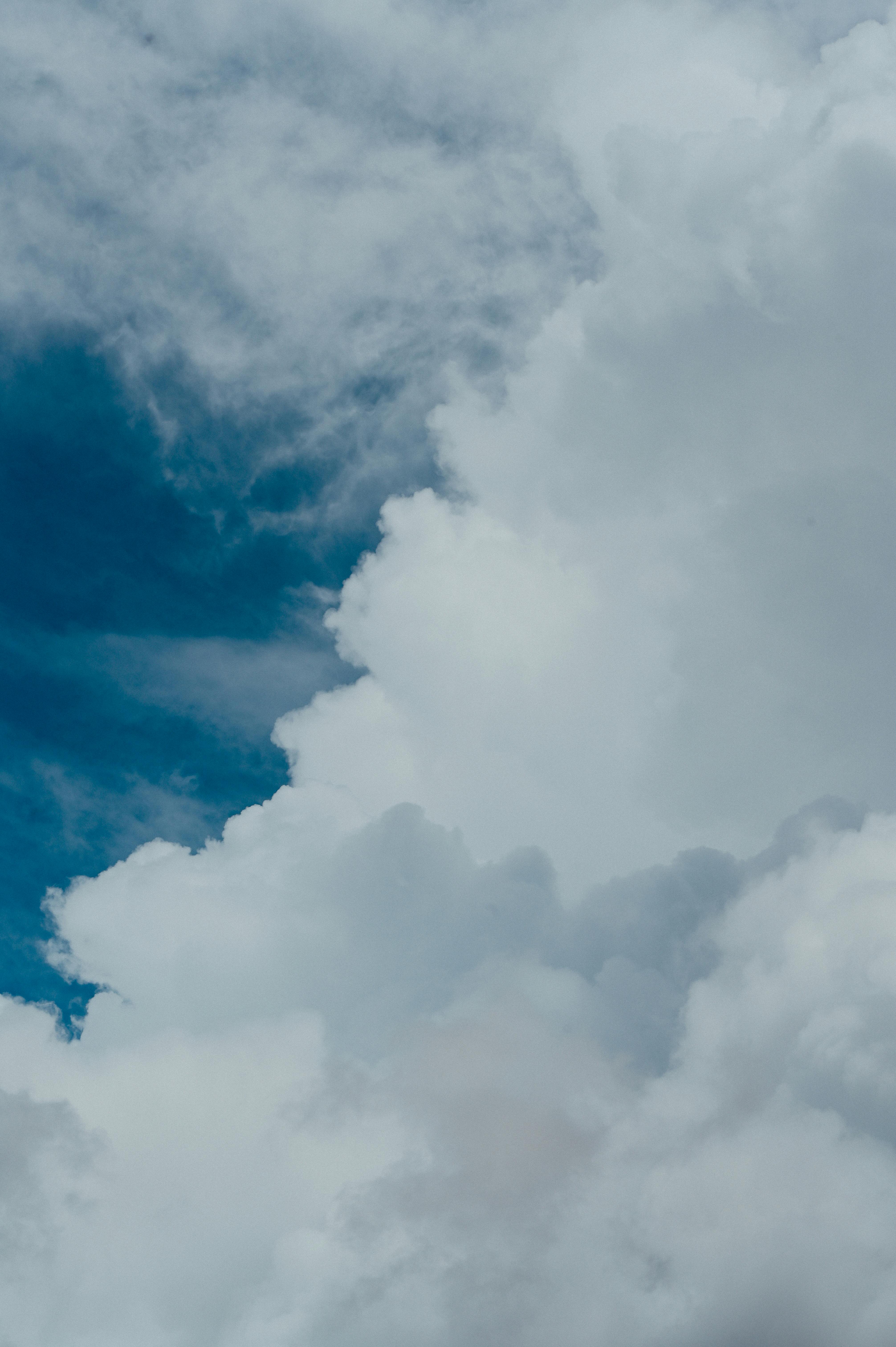A breathtaking view of cumulus clouds towering against a clear blue sky, evoking a sense of wonder.