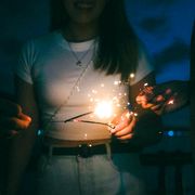 Holding a sparkler at dusk — photo by Traveler stories photos on Pexels