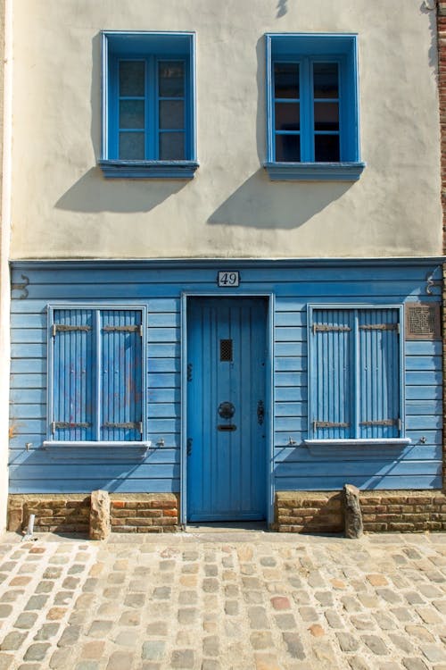 Wooden Blue Door and Windows of a House