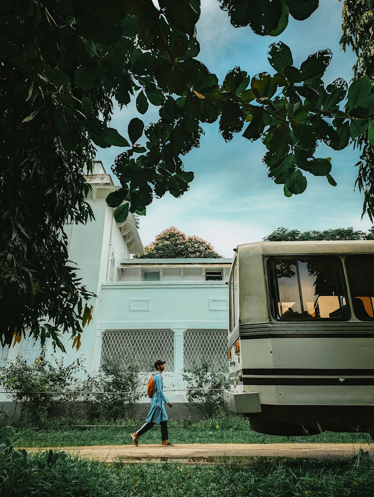 Person With Backpack By Bus