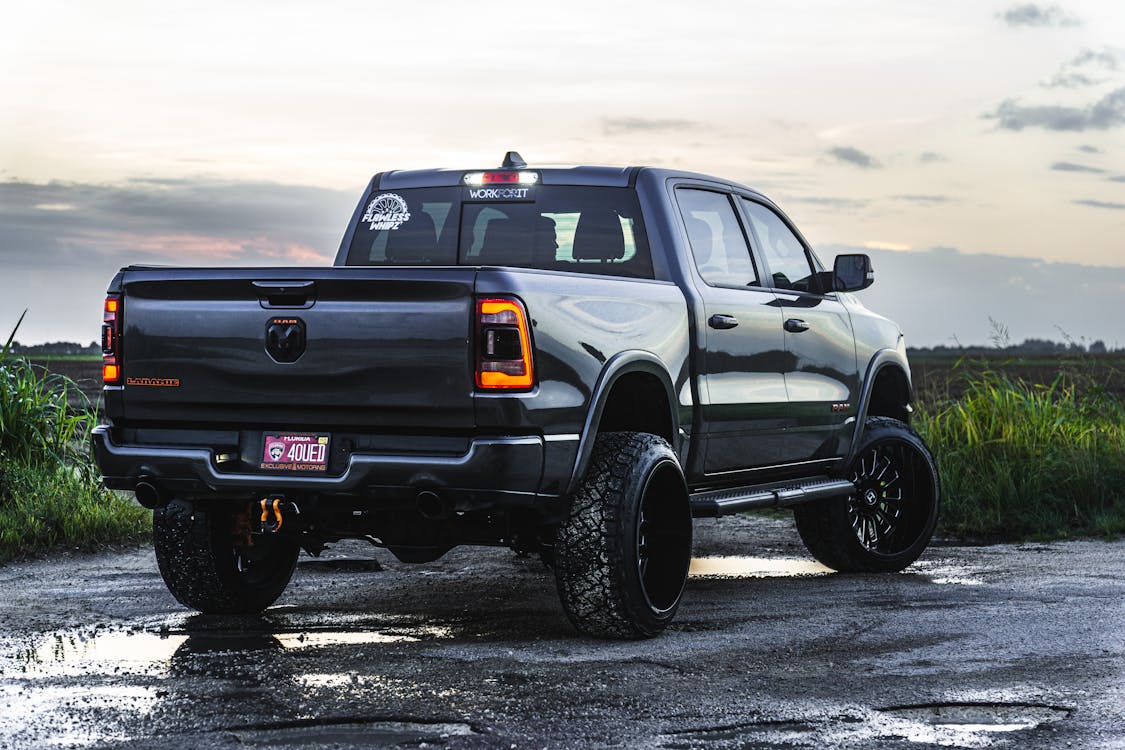 Free A powerful pickup truck parked on a gravel road at dusk. Perfect for automotive enthusiasts. Stock Photo