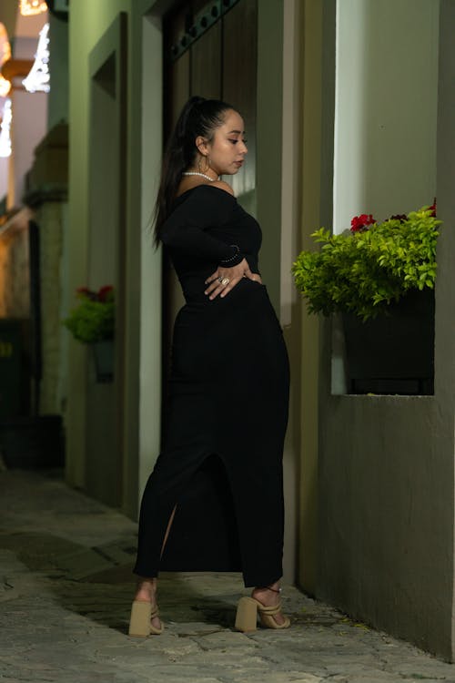 Woman Posing in Black Dress in Alley in Town