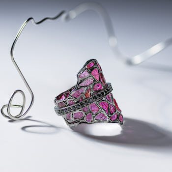 Stylish mosaic gemstone ring captured on a minimalist white background, highlighting intricate details.