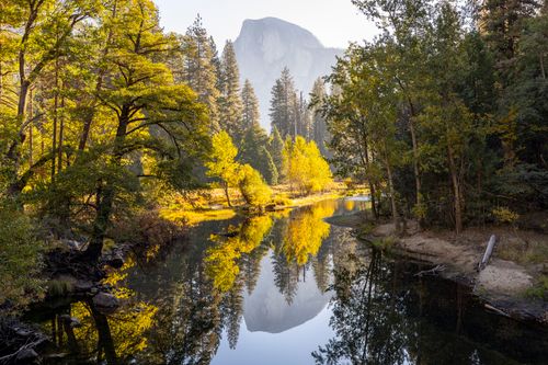 Free Serene river landscape with autumn trees in Yosemite National Park. Stock Photo