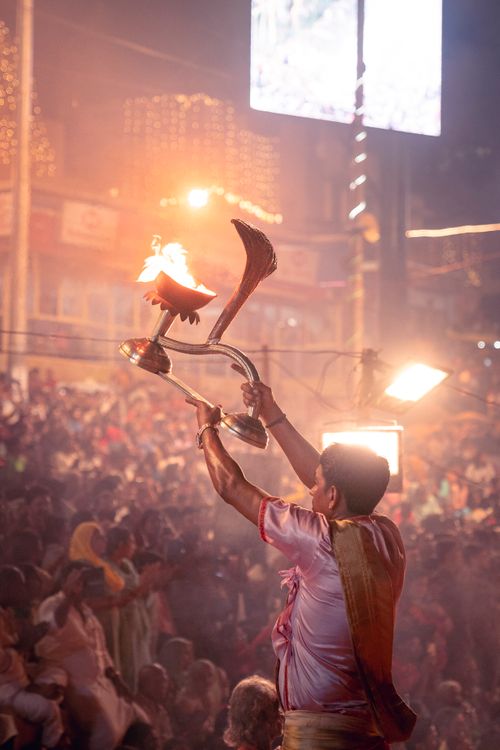 Free An Indian man performs a ritual with a flamethrower during a crowded festival celebration. Stock Photo