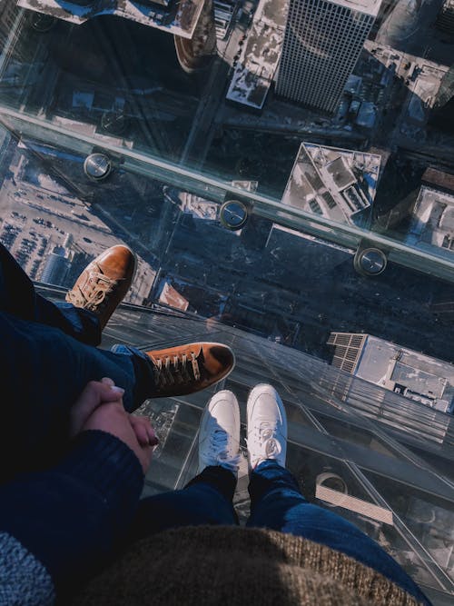 People Standing On Top Of A Building