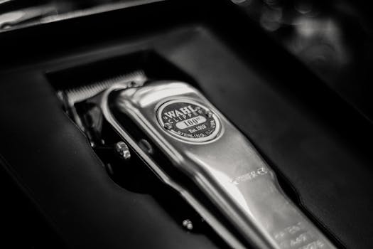 A detailed close-up of a shiny metal cordless clipper in its box, highlighting the sleek design.