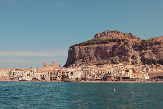 Explore the stunning seaside architecture of Cefalù, Sicily, with rocky backdrops and historic charm.