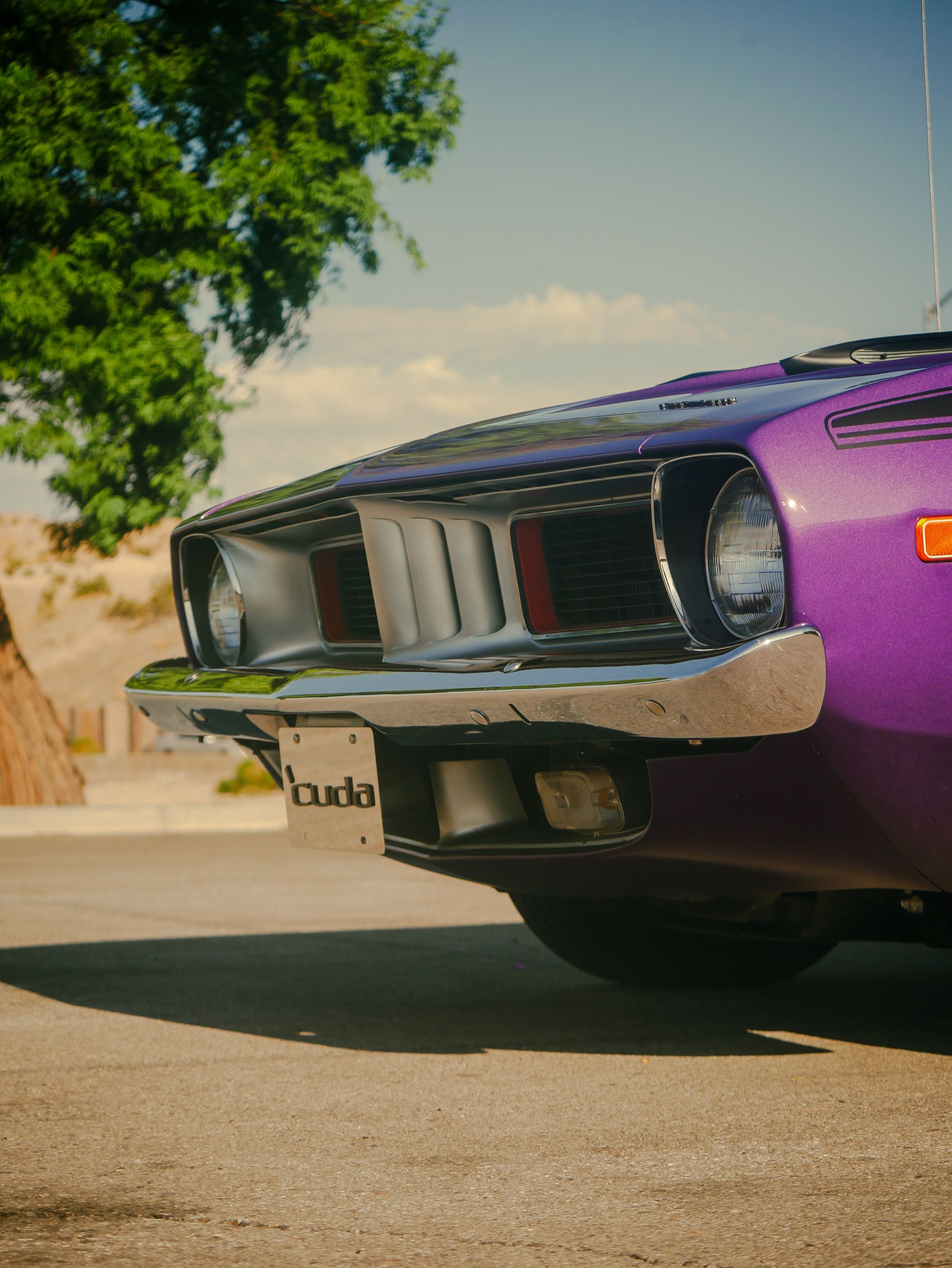 Shows a Barracuda muscle car front end &mdash; the partial badge visible confirms the model &mdash; directly relevant to the article&hellip;