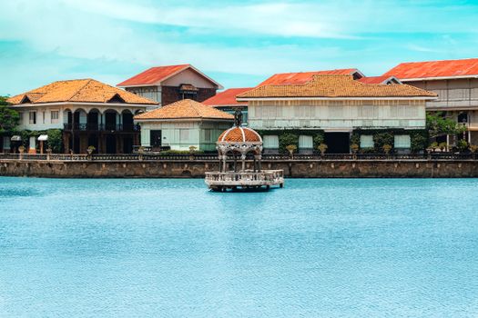 Picturesque lakeside view of Las Casas Filipinas de Acuzar in Bagac, Philippines, featuring traditional Filipino architecture.