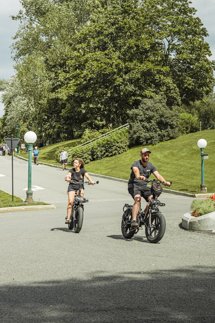 Couple Riding On Bikes In A Park