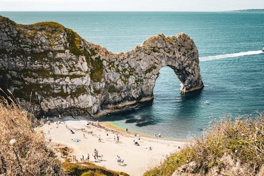 Beautiful summer scene at Durdle Door, a natural limestone arch on the Jurassic Coast of England.