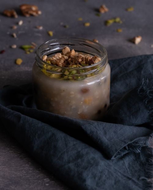 Free Homemade oatmeal in a jar with nuts and seeds on a dark tablecloth. Stock Photo