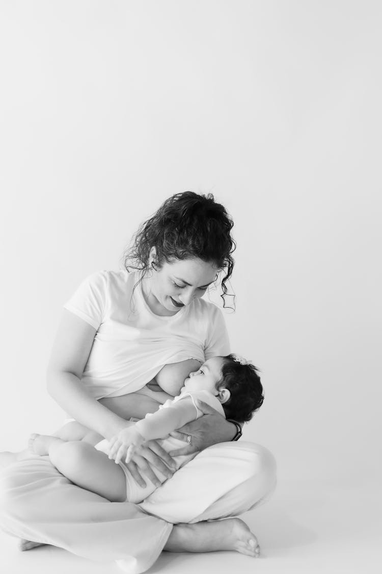 Mother Hugging Her Child In Black And White