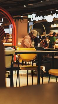 An inviting cafe atmosphere indoors, featuring people and modern seating.