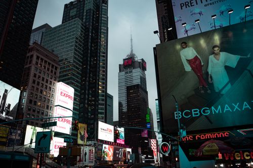 Free A bustling view of Times Square at dusk, showcasing towering skyscrapers and vibrant billboards. Stock Photo