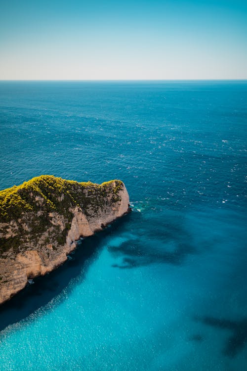 Aerial View of a Rock on the Turquoise Ocean