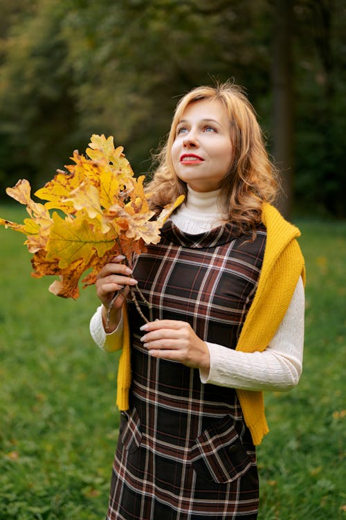 Young Woman with Autumn Leaves in her Hands