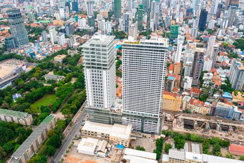 Free Stunning aerial view of Phnom Penh's diverse cityscape with modern skyscrapers and lush greenery. Stock Photo