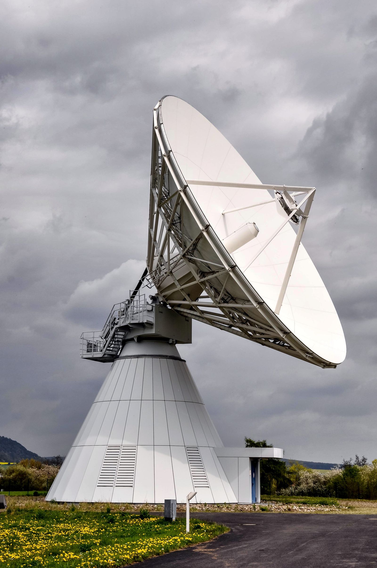 Large satellite dish under cloudy sky