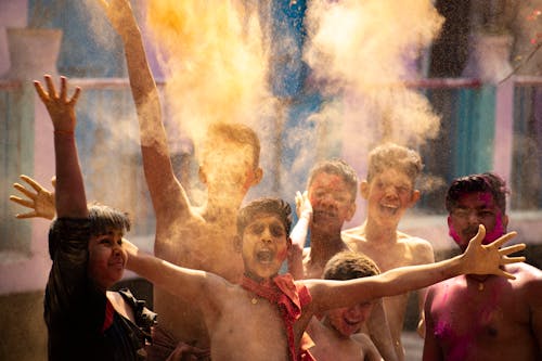 Group of Teenagers Scattering Gulal Powder on Hindu Festival of Colors