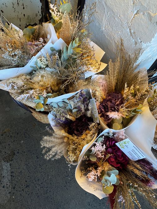 Bundles of dried flowers arranged together, photo by Hope Pontifex on Pexels