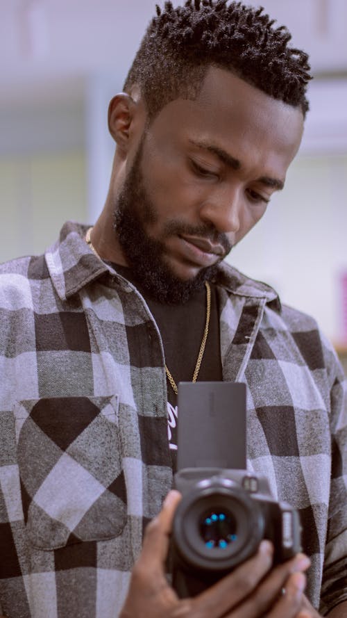 Man Looking at the Digital Camera Display