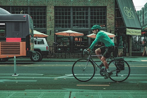 Cyclist Riding the Bicycle Lane Along the Street