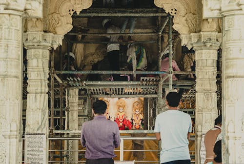 Men Working on Scaffolding in Old Stone Traditional Shrine