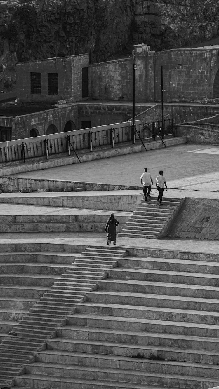 People Walking On Stairs In Black And White