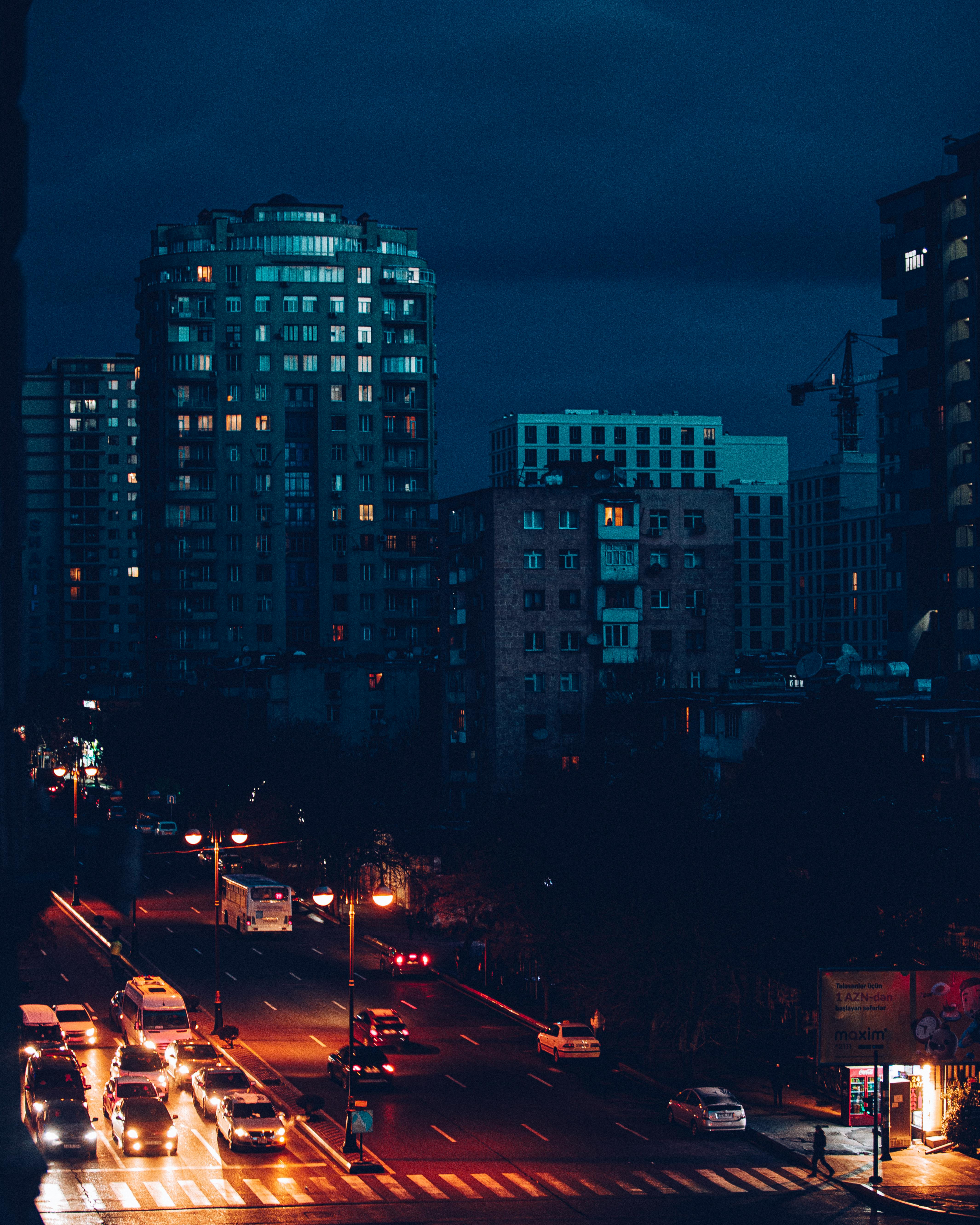 Vibrant cityscape at night with illuminated streets and tall buildings.