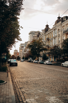 Charming view of cobblestone street in Kyiv, Ukraine, with beautiful historic architecture and a serene evening glow.