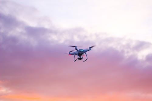 Quadcopter Drone Flying Under Pink Sky