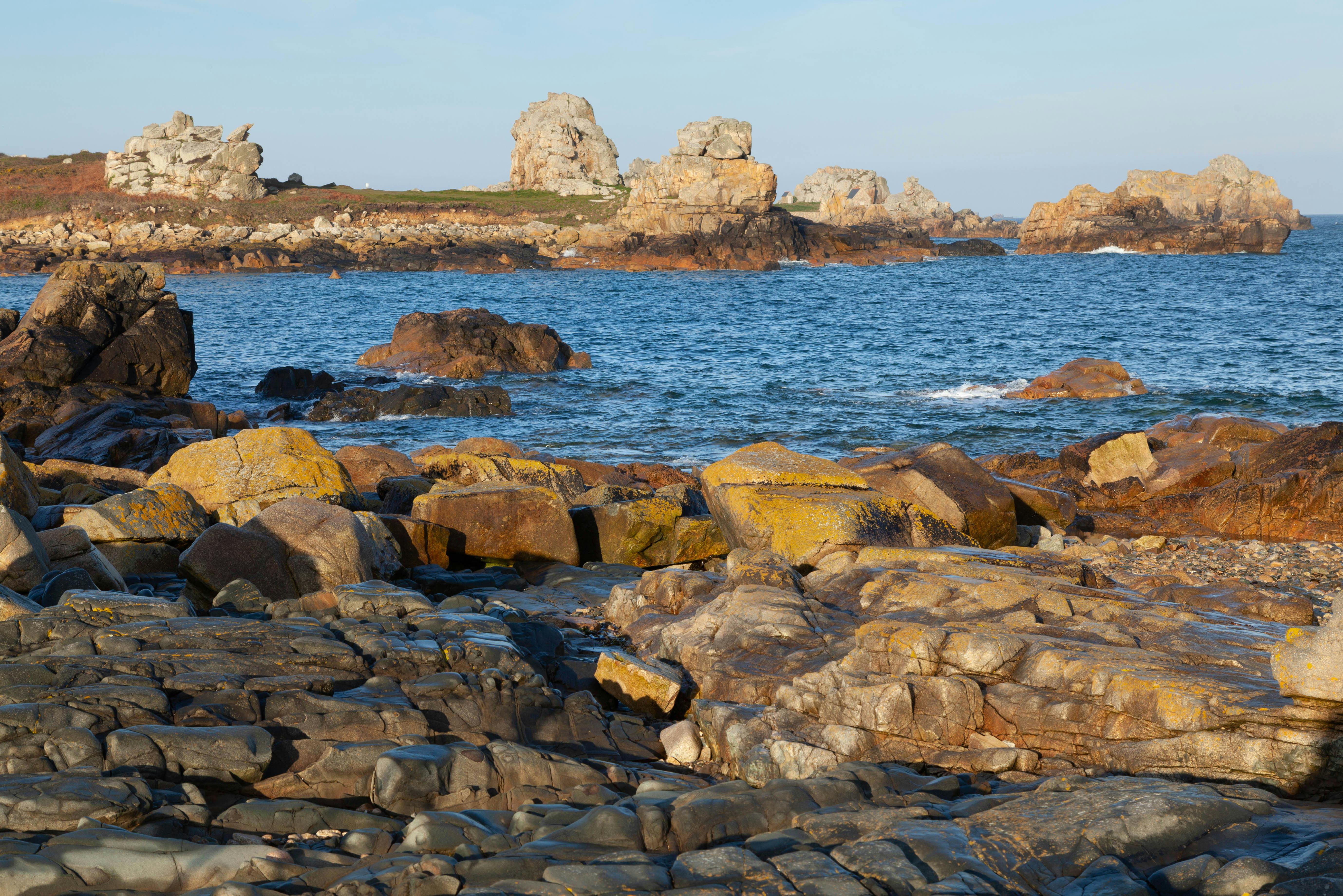 a rocky shoreline with rocks and water