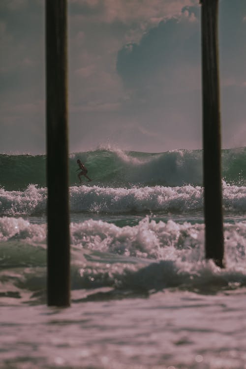 Surfer on Waves on Sea Shore