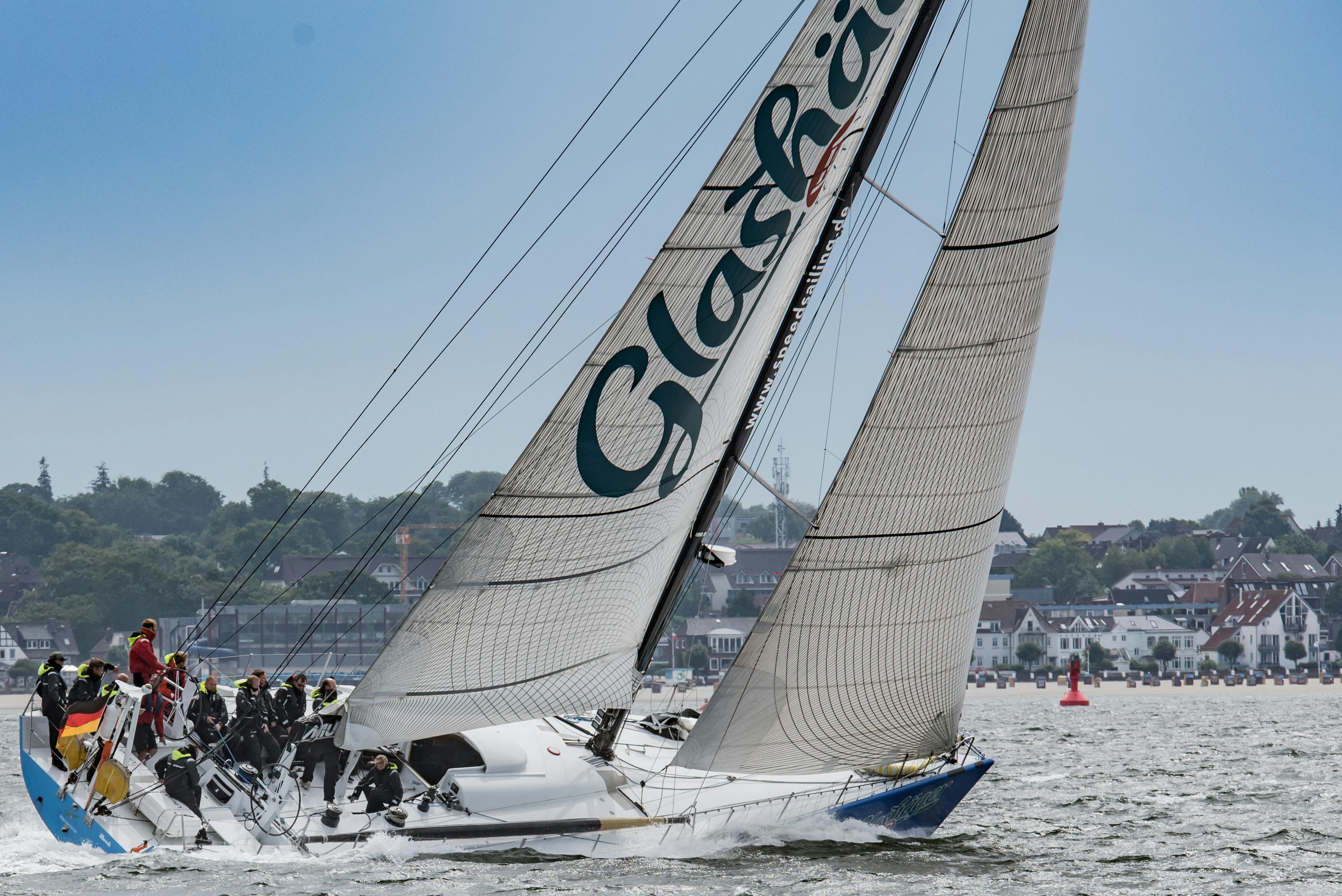 A sailboat with a team racing near Laboe, Germany on a sunny day.