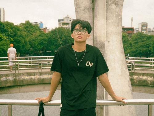 Free A young man with glasses poses in an urban setting. Ideal for lifestyle themes. Stock Photo