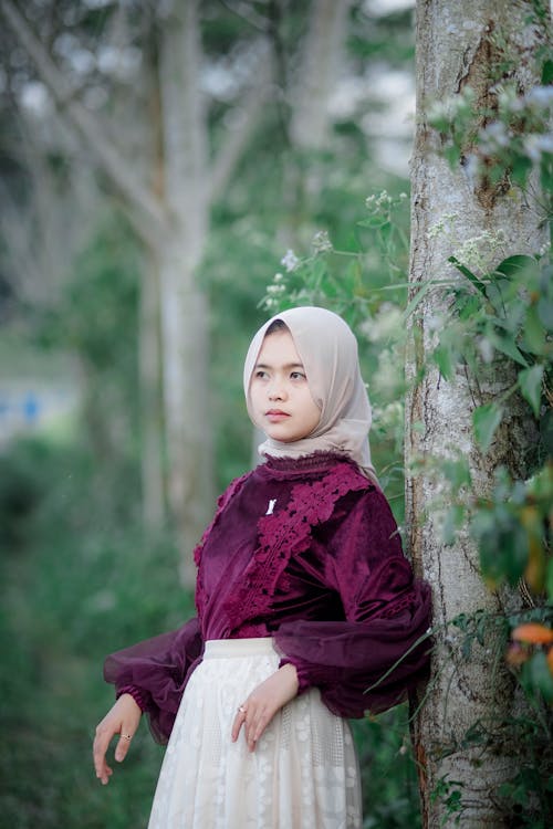Woman in Hijab Standing by Tree