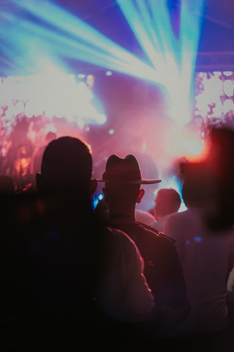 Concert audience under stage lighting, illustrative music photograph