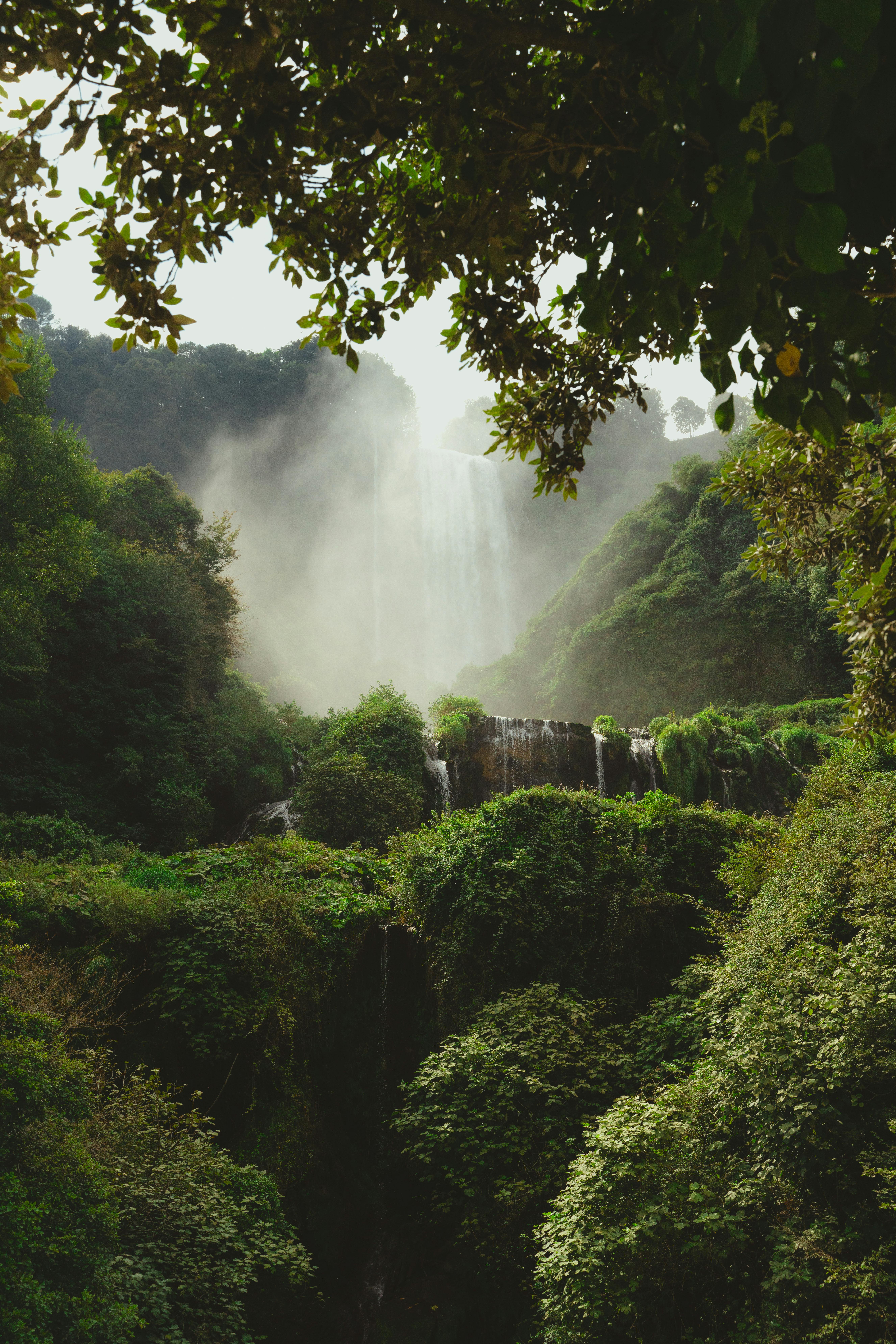 Stunning waterfall cascading through lush greenery in Umbria, Italy, a perfect nature escape.