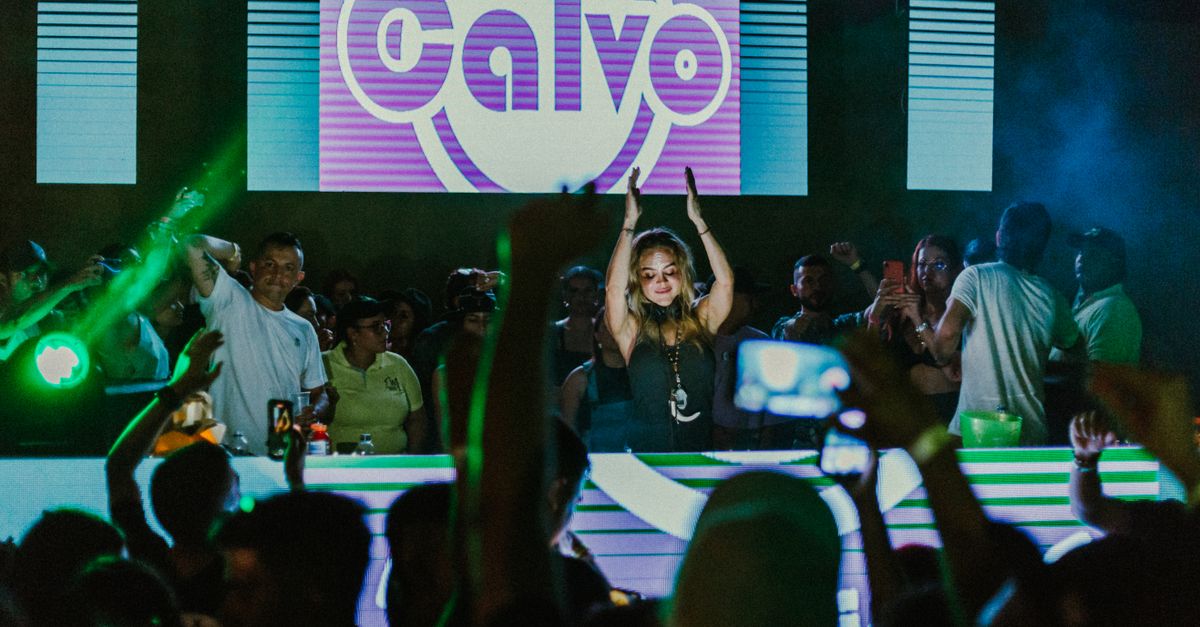 Young people dancing in a modern church with stage lighting and LED screens