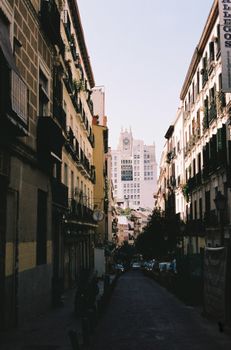 Vertical shot capturing a classic street view in Madrid's Manuela Malasaña neighborhood.