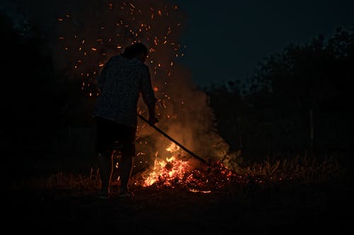 Man Burning Fire in Nature in Dark