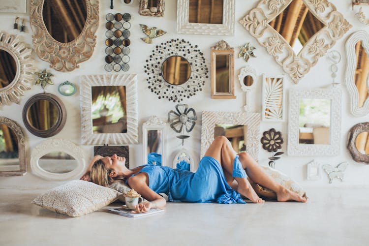 Woman Lying On The Floor Near Wall Mirrors