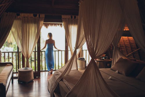 Free Woman Leaning on Handrail in Room Stock Photo