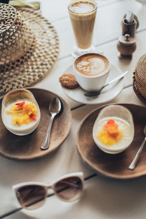 Free Latte Near Two Desserts in Glasses Stock Photo