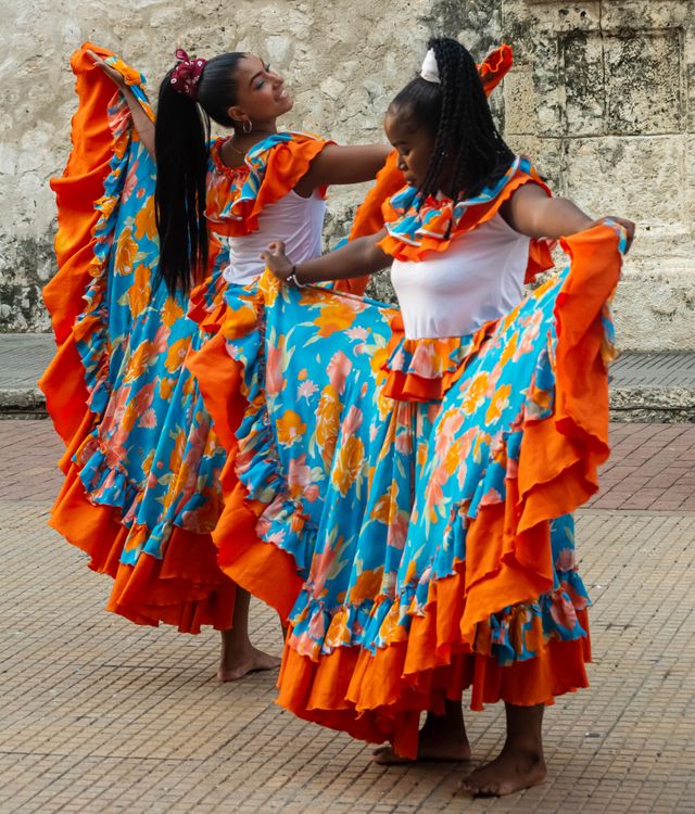 Smiling Women Dancing in Traditional Clothing · Free Stock Photo
