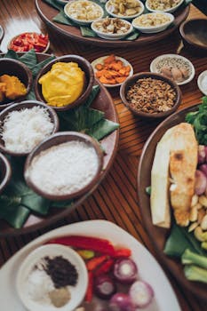 A vibrant assortment of spices and ingredients displayed on a wooden table, perfect for culinary exploration.